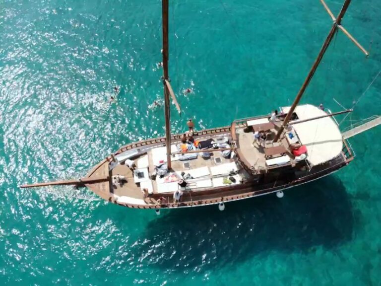 Aerial view of Motor Sailer 69 cruising the turquoise waters during the island hopping adventure from Athens to Agistri, Moni, and Aegina. Events On Board.