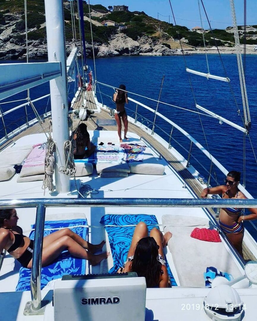 A sunny day on the deck of the 89ft gulet with guests enjoying the view and relaxation on the Delos & Rhenia Islands cruise with Events on Board.