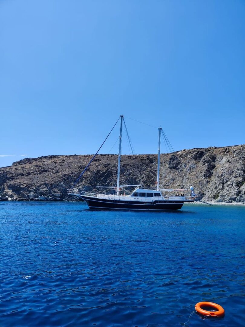 Guests exploring the stunning Rhenia Island from the deck of the 89ft gulet during the shared cruise with Events on Board.