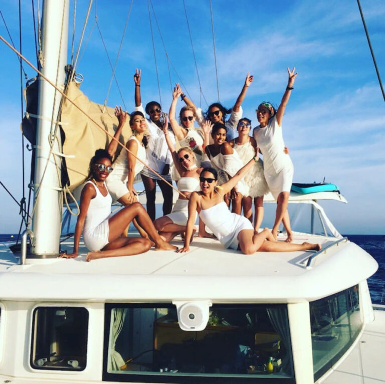A group of friends celebrating a bachelorette party on the Lagoon 420 Catamaran, enjoying drinks and fun in the sun with Events on Board.