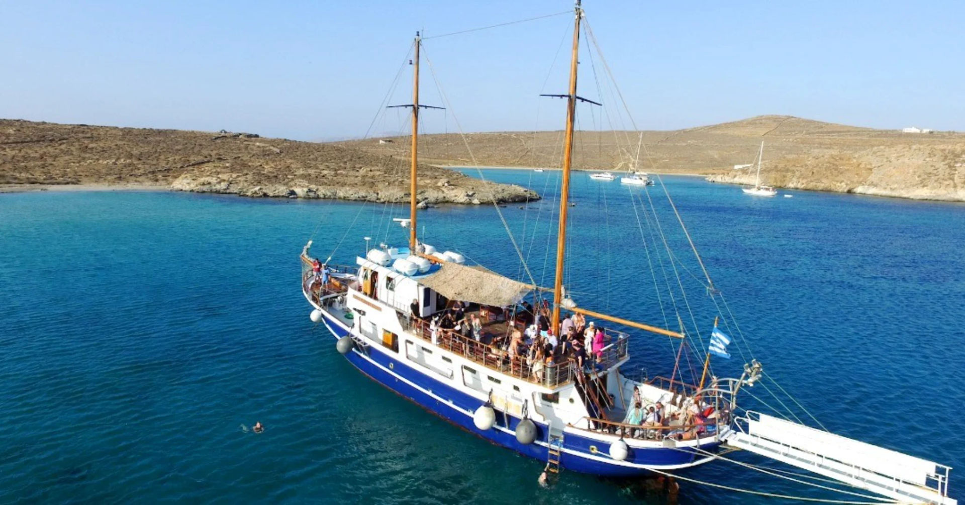 The Liberty 31 schooner setting sail from Mykonos, offering a unique cruising experience with Events on Board.