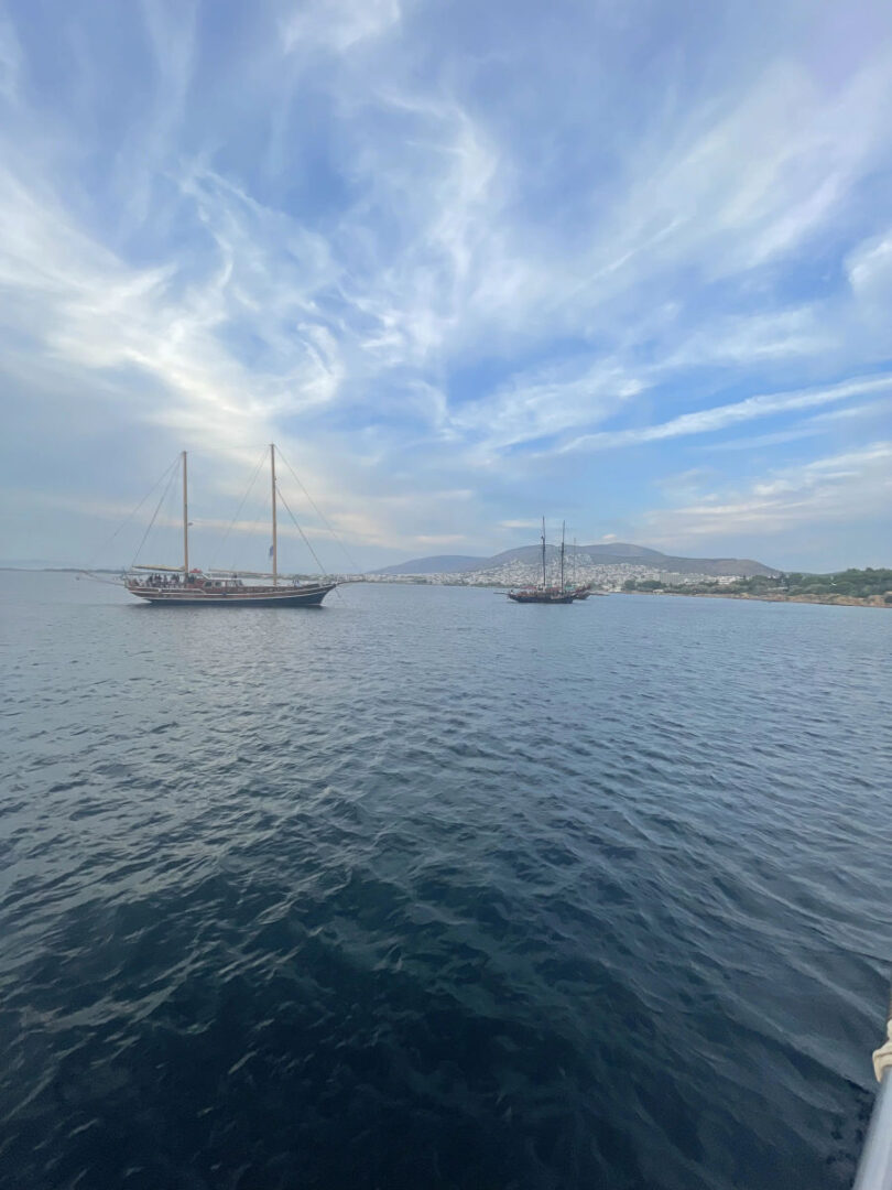 Traditional Greek gulets participating in the Wooden Regatta Event in Athens with a view of the city, hosted by Events on Board.