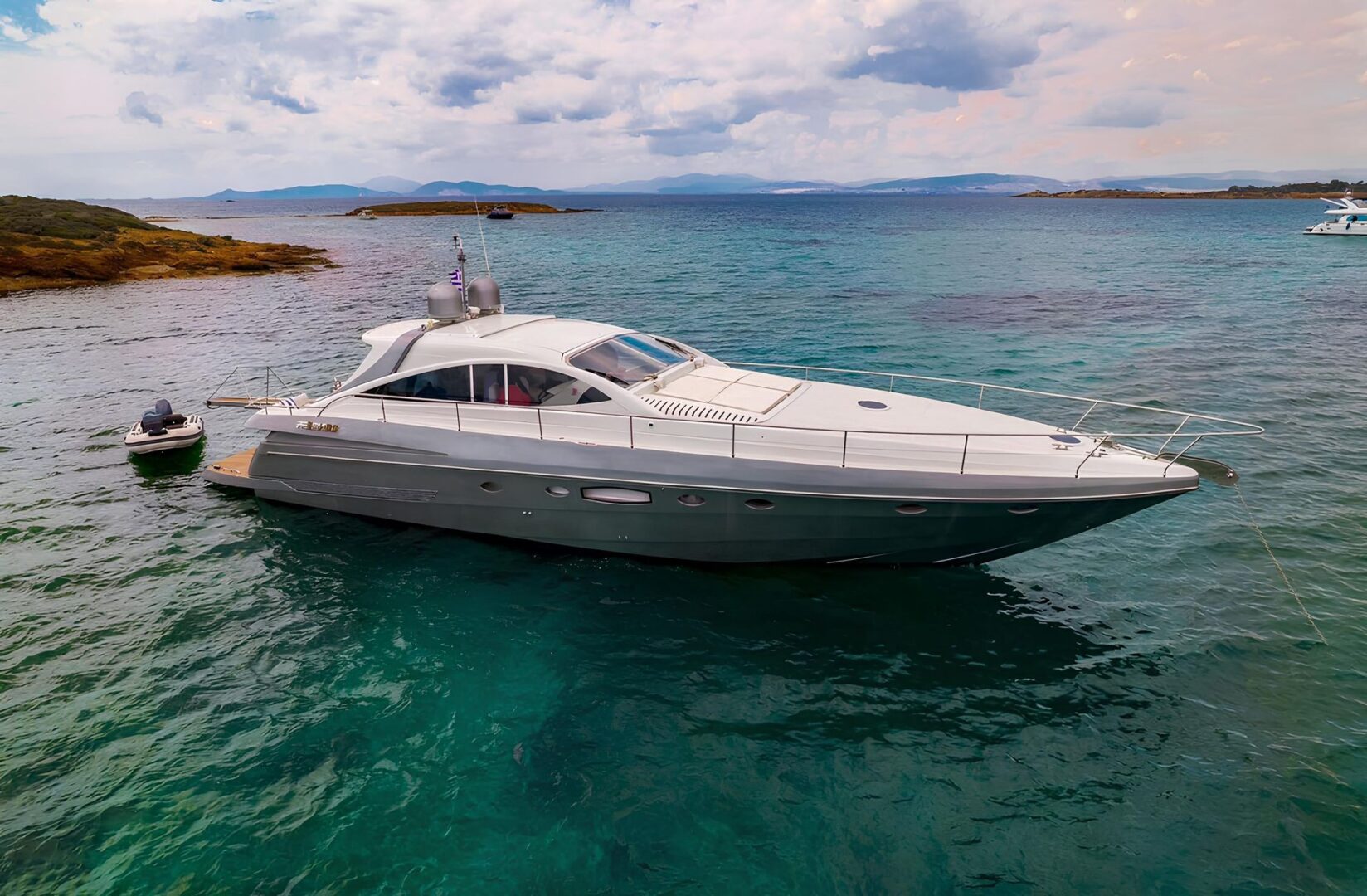 Sleek and stylish Pershing 65 motor yacht anchored in Mykonos, perfect for exclusive party cruises with Events on Board.